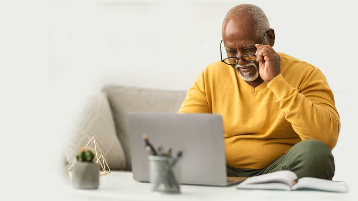 happy man looking at his laptop