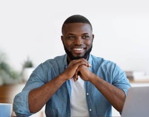 confident smiling man with interlocked hands