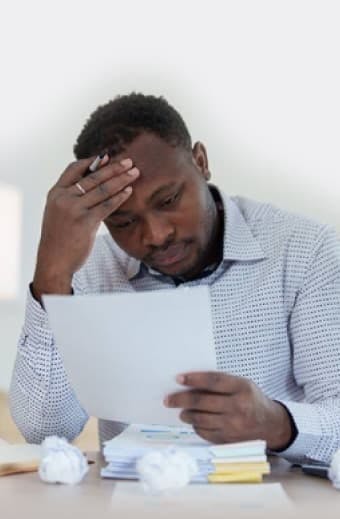 stressed man reviewing documents